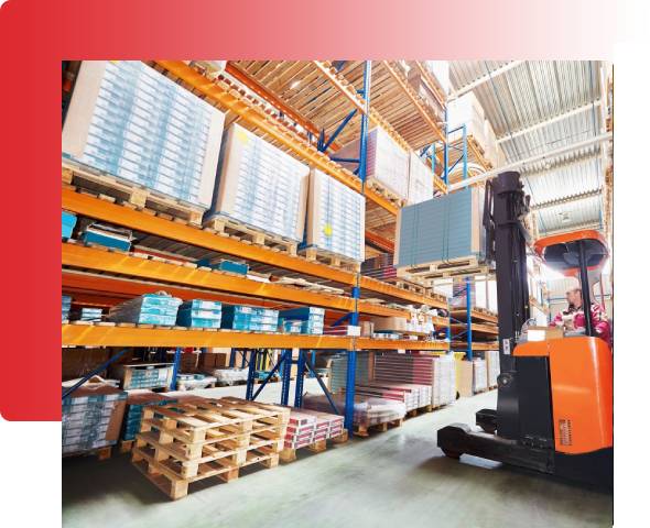 A forklift is parked in front of some shelves.