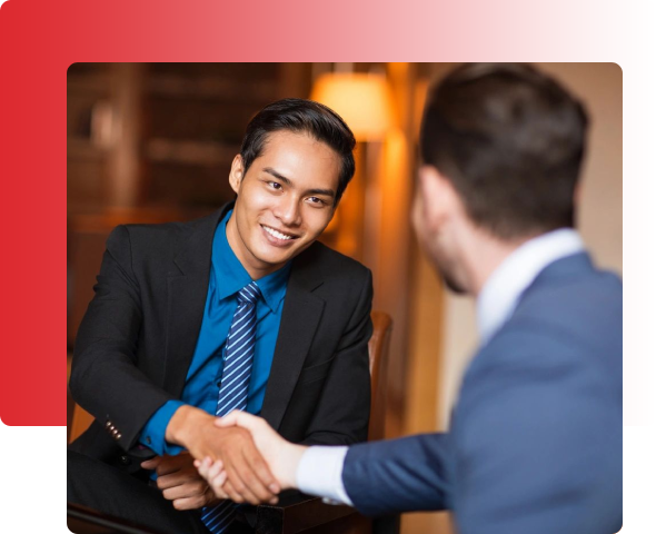 Two men shaking hands in a room.